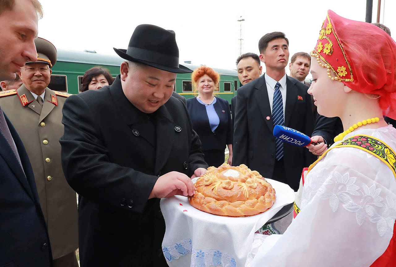 North Korean leader Kim Jong Un (center) receives bread and salt on his arrival Wednesday at Khasan train station, Primorsky Krai region, Russia. (Korean Central News Agency/Korea News Service via AP)