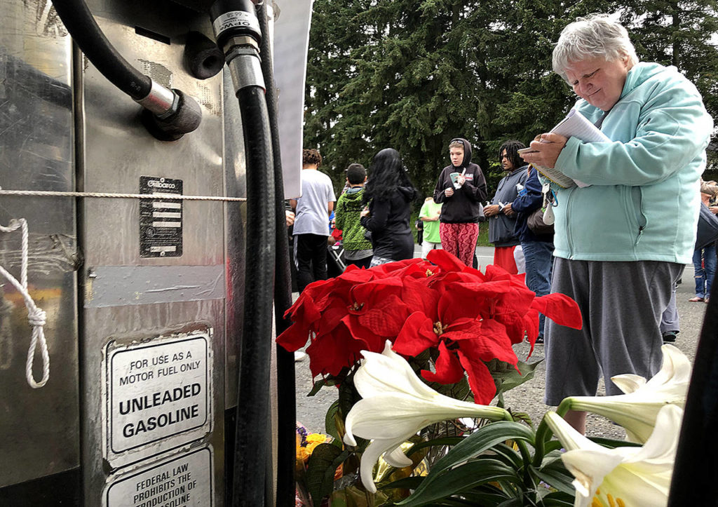 Dozens of people gathered Thursday night to remember Jae An, 58, a mini mark clerk killed in a robbery on Broadway in Everett. (Caleb Hutton / The Herald)
