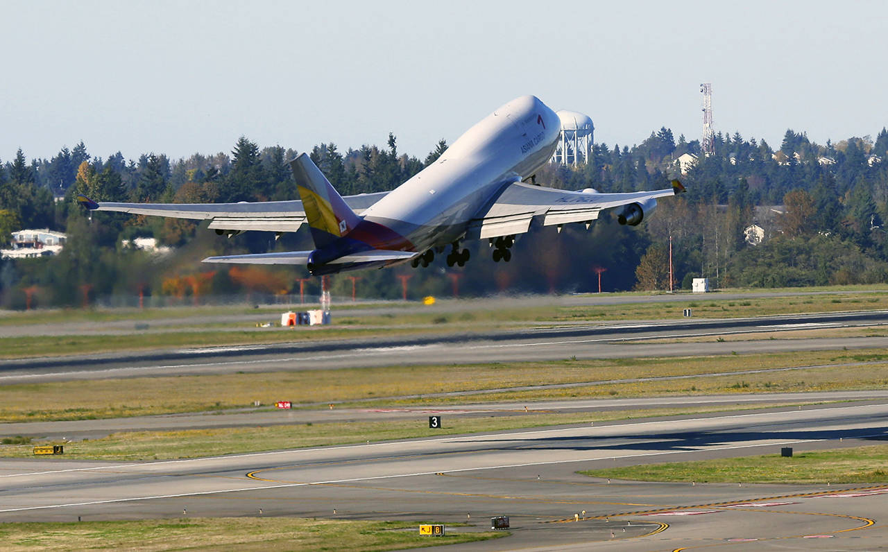 In this 2013 photo, an Asiana Airlines Boeing 747 cargo plane takes off at Seattle-Tacoma International Airport in Seattle. (AP Photo/Ted S. Warren, file)