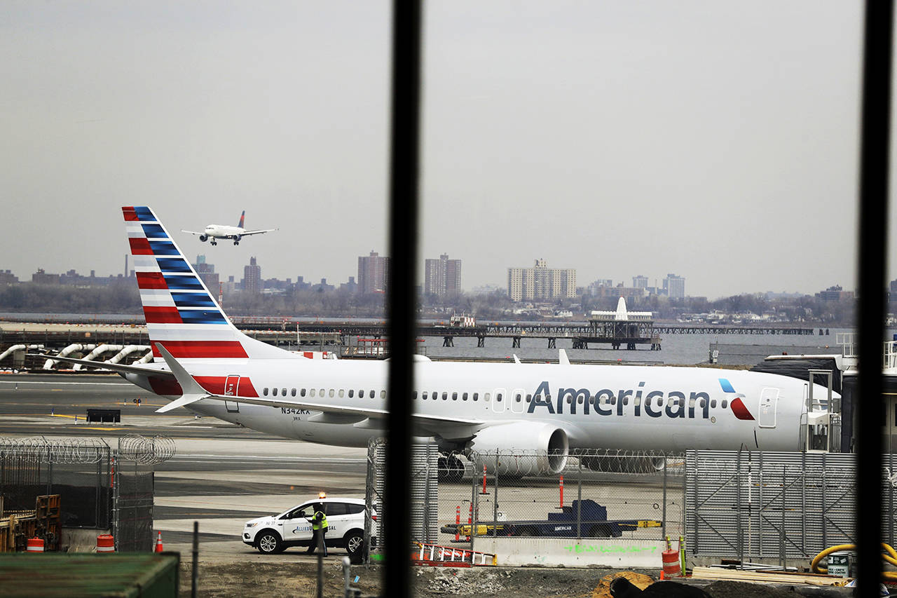 In a March 13 photo, an American Airlines Boeing 737 MAX 8 sits at a boarding gate at LaGuardia Airport in New York. (AP Photo/Frank Franklin II, File)