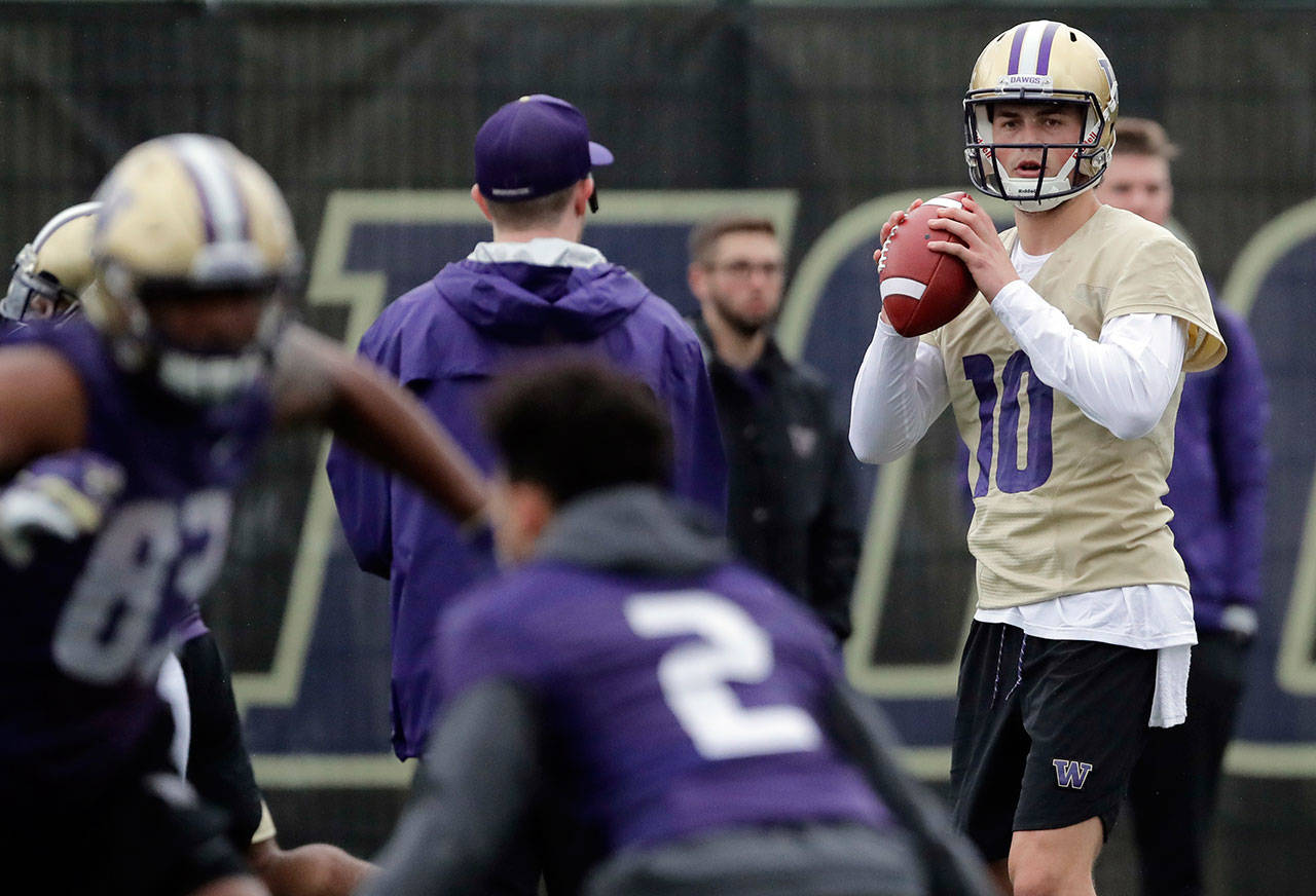 Washington quarterback Jacob Eason (right) looks to pass during a spring practice on April 3, 2019, in Seattle. (AP Photo/Ted S. Warren)