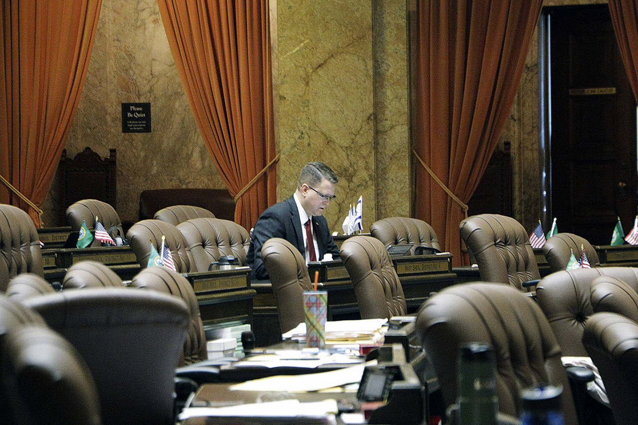 Republican Rep. Matt Shea sits at his desk on the House floor on Friday in Olympia. Shea has been dogged this week by the release of text messages from 2017 in which he appeared to condone surveillance and even violence against political enemies. (AP Photo/Rachel La Corte)