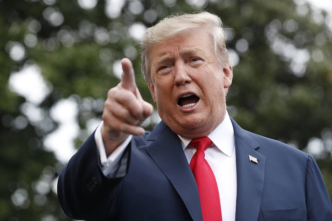 President Donald Trump speaks to the media as he departs the White House on Friday. (AP Photo/Jacquelyn Martin)