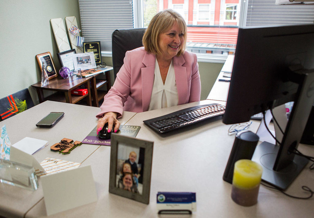 Barbara Tolbert smiles as she talks about some of the emails she receives from community members in her office on Wednesday, April 17, 2019 in Arlington, Wash. (Olivia Vanni / The Herald)
