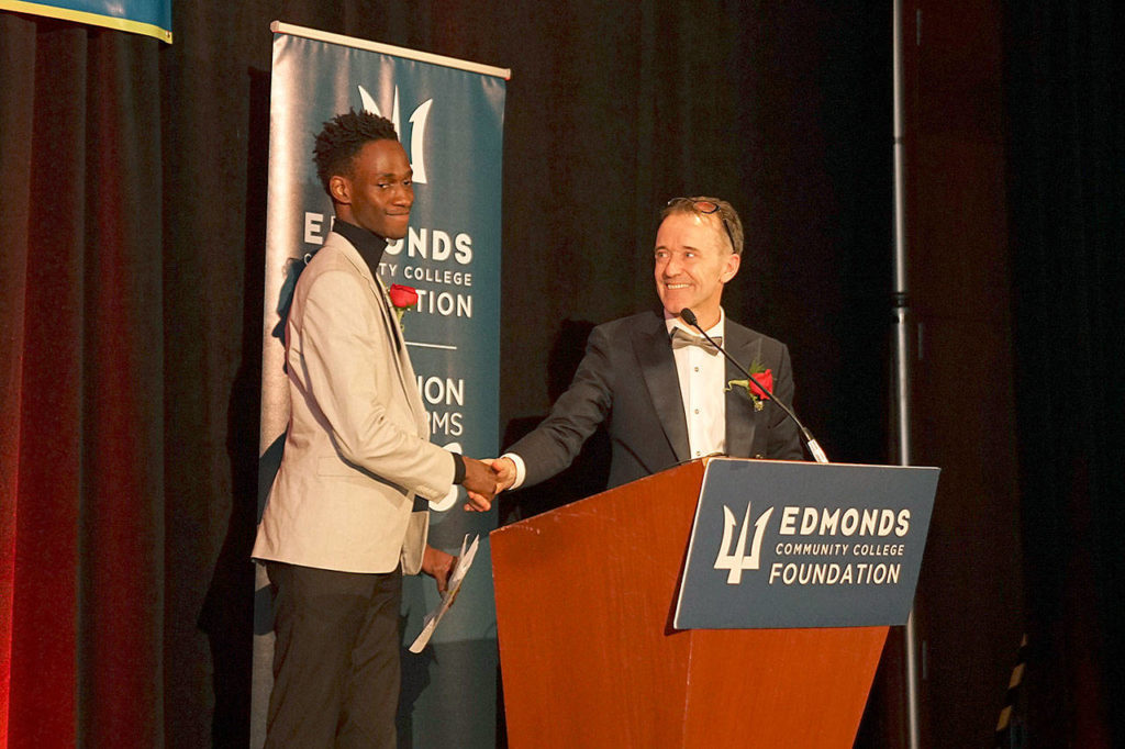 Kevin Joyce (right), emcee for the Edmonds Community College Foundation’s awards gala, presents student Mustapha Samateh the Student Spotlight. Samateh shared his story of overcoming adversity when he came to the U.S. as a student seeking political asylum from The Gambia. (Edmonds Community College)
