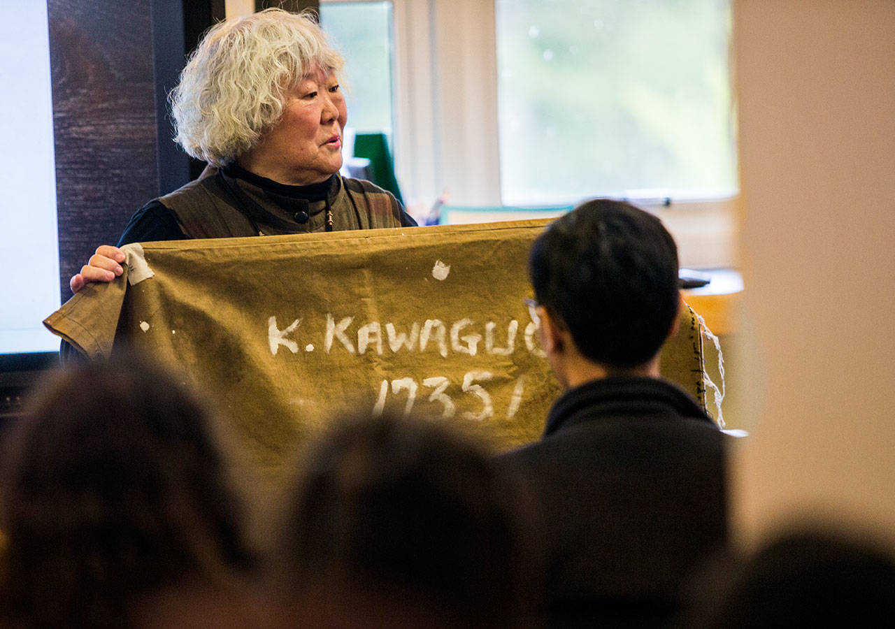 Judy Kusakabe displays a bag that was used to hold belongings. (Olivia Vanni / The Herald)