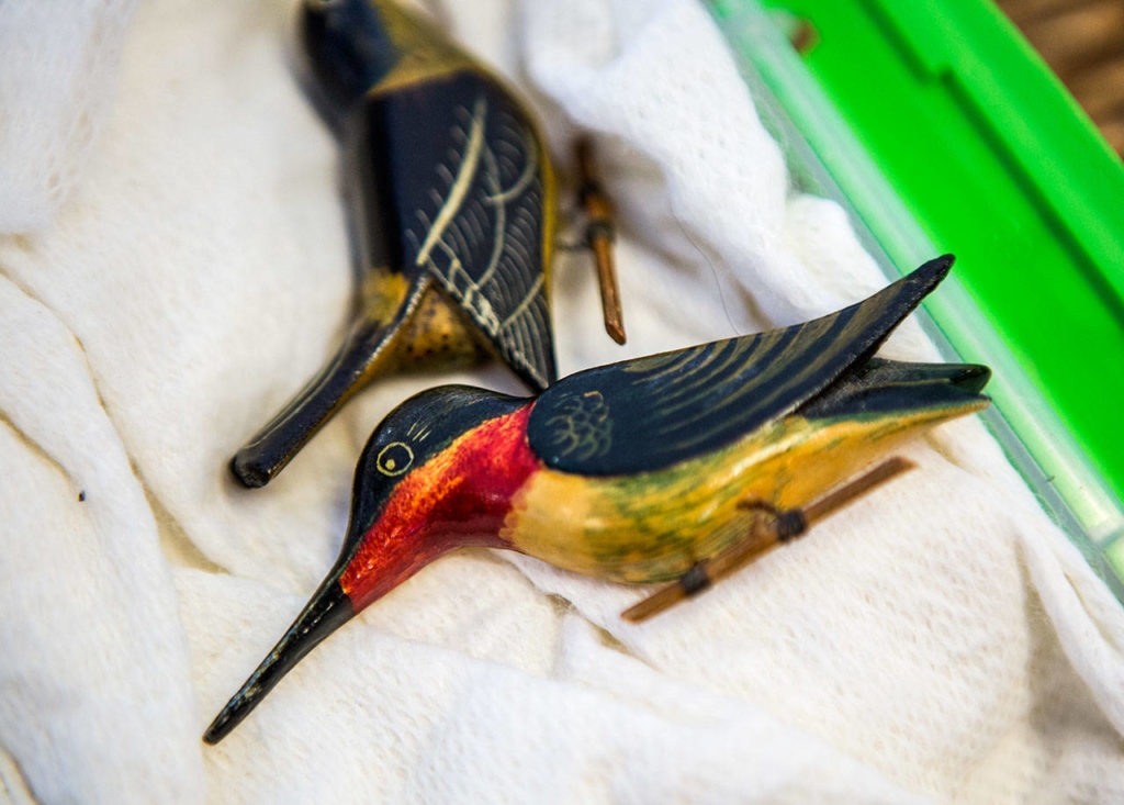 A wooden hummingbird that was made in an internment camp is displayed during Judy Kusakabe’s talk at Kamiak High School. (Olivia Vanni / The Herald)

