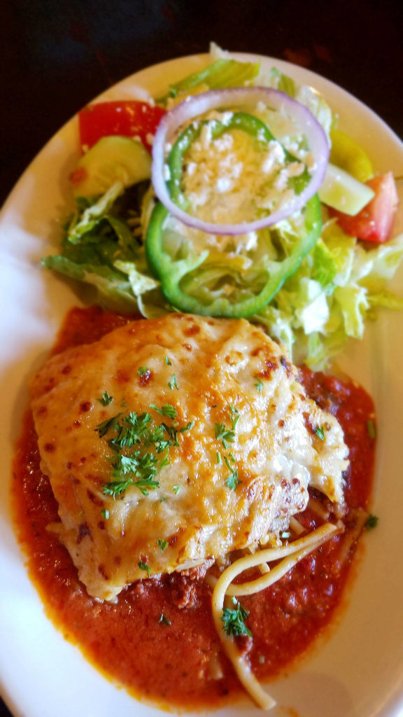 Kafe Neo’s pastitsio is made with layered pasta, beef and bechamel sauce, topped with tomato sauce, and served with salad and pita. (Sharon Salyer/The Herald)
