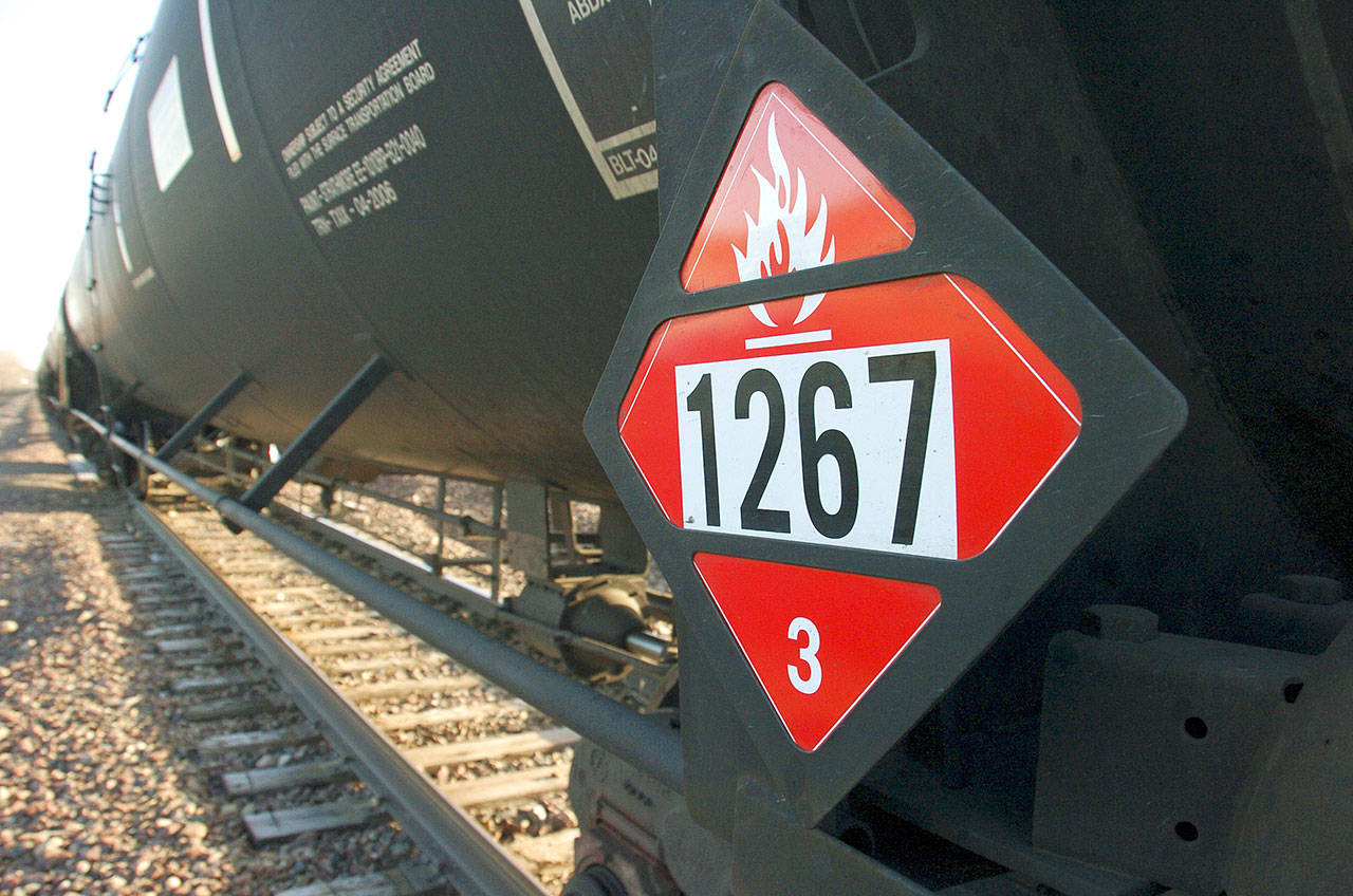 A warning placard is shown on a tank car carrying crude oil near a loading terminal in Trenton, North Dakota, in 2013. (AP Photo/Matthew Brown, File)
