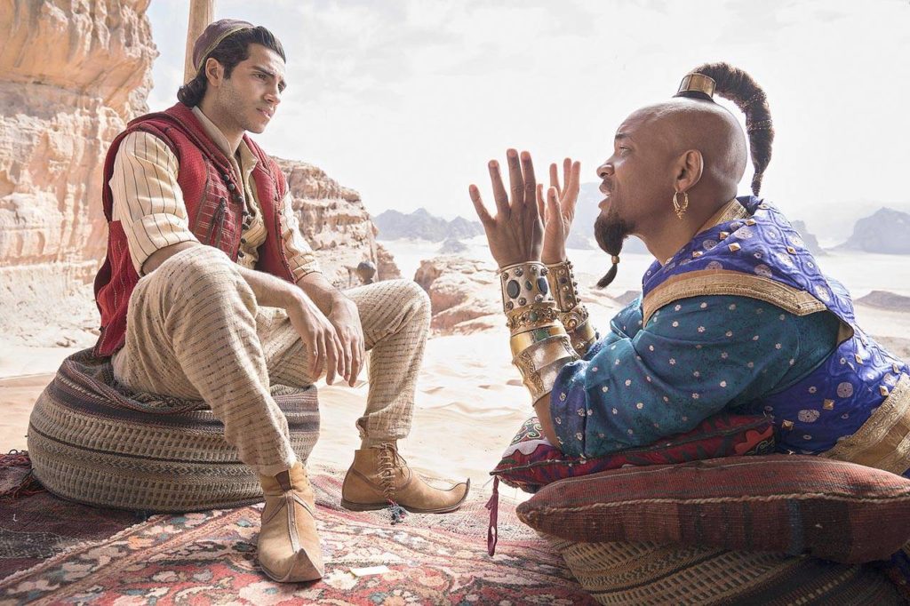 Mena Massoud and Will Smith (in the Robin Williams role) in a live-action remake of “Aladdin,” coming May 24. (Walt Disney Pictures)
