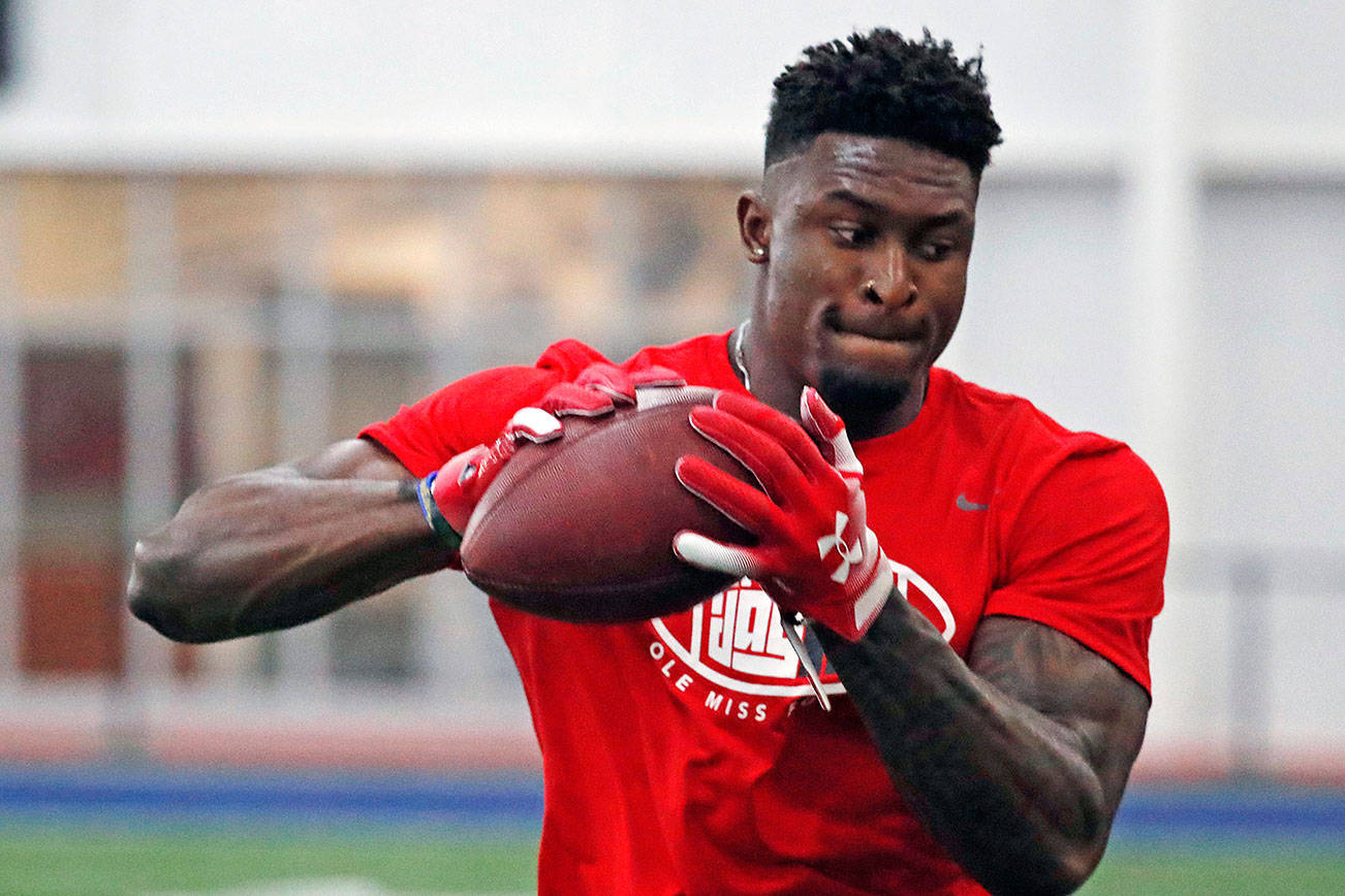 Former Mississippi football wide receiver DK Metcalf catches a pass while running pass patterns runs as he is tested by NFL scouts and coaches during Pro Day at Mississippi, Friday, March 29, 2019, in Oxford, Miss. (AP Photo/Rogelio V. Solis)