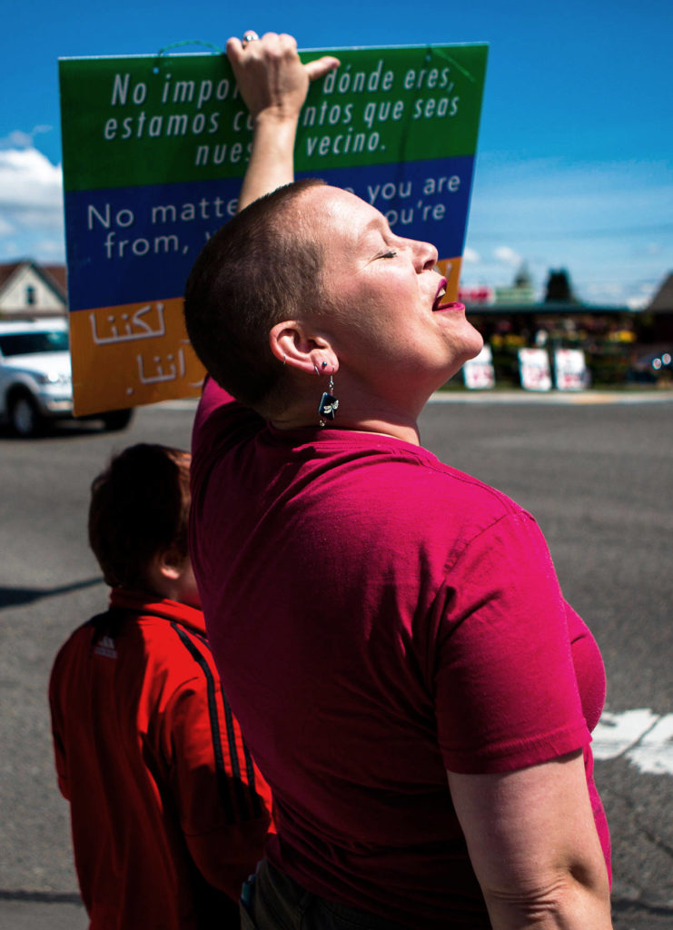 Liz Vogeli, an Everett City Council member, helps start a chant during the monthly march in solidarity with immigrants and refugees on Sunday in Everett. (Olivia Vanni / The Herald)
