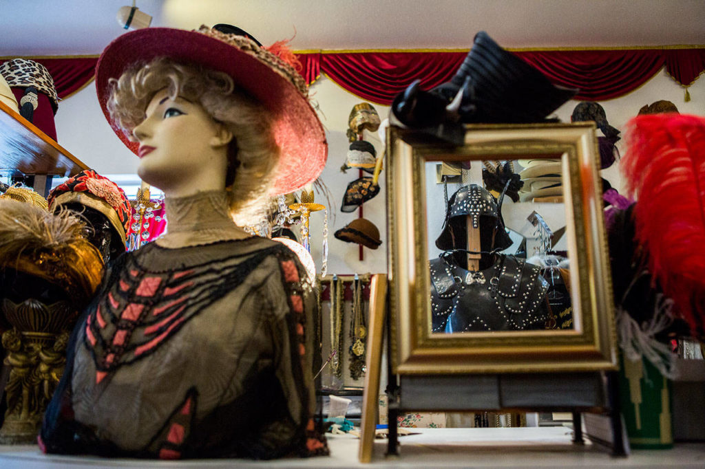Hats, clothing and a handmade leather suit of armor on display at Vintage Costumers in Everett. (Olivia Vanni / The Herald) 
