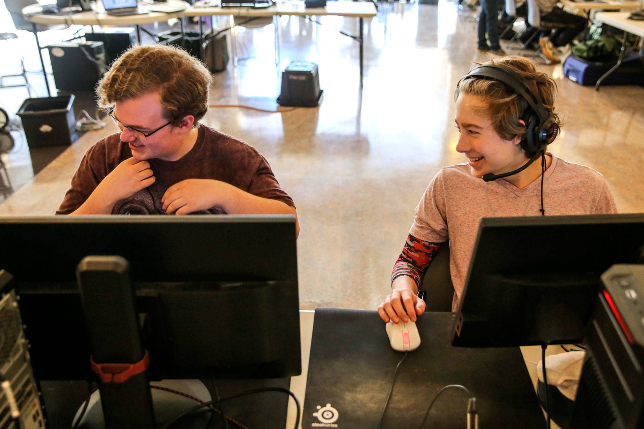 Matthew Burdick (left) and Parker Walters share a laugh during a Northwest ESports Counter-Strike tournament on April 27, 2019, at Willis Tucker Community Activity Center in Snohomish. (Kevin Clark / The Herald)