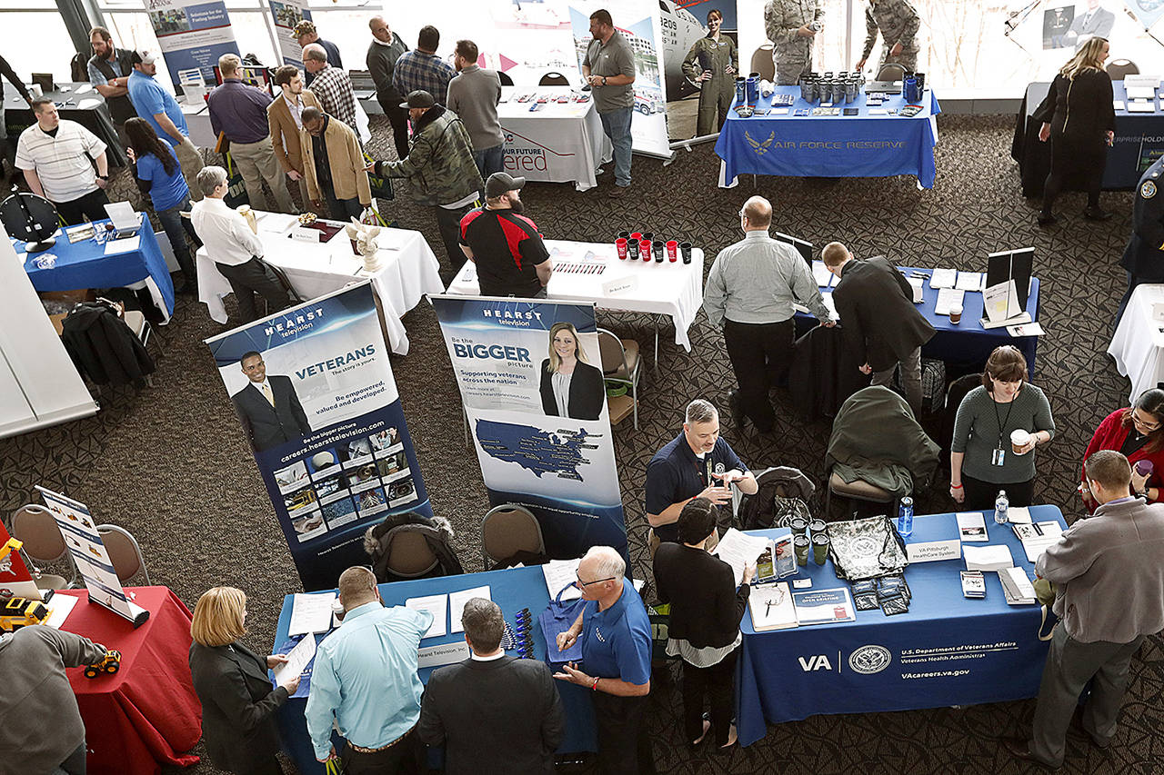 In this March 7 photo, visitors to the Pittsburgh veterans job fair meet with recruiters at Heinz Field in Pittsburgh. (AP Photo/Keith Srakocic, File)