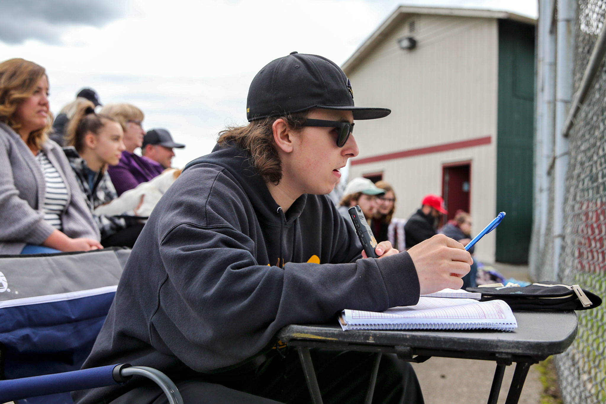 Lake Stevens senior Payne Patchett records play-by-play audio during a Vikings baseball game last month. The talented 18-year-old broadcaster recently landed a minor-league baseball radio job as the play-by-play voice of the Salem-Keizer Volcanoes. (Kevin Clark / The Herald)