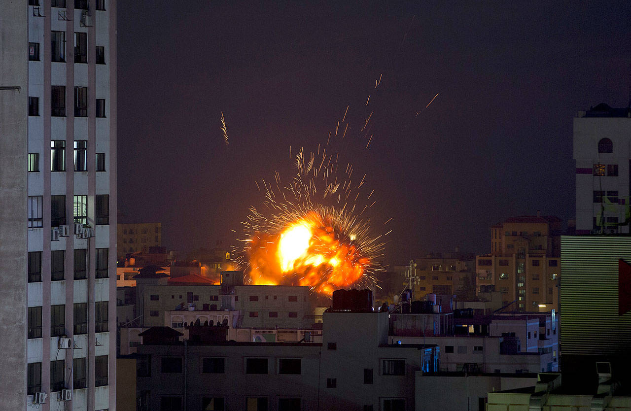 An explosion caused by an Israeli airstrike on a building in Gaza City on Saturday. Palestinian militants in the Gaza Strip fired at least 90 rockets into southern Israel on Saturday, according to the Israeli military, triggering retaliatory airstrikes and tank fire against militant targets in the blockaded enclave and shattering a month-long lull in violence. (AP Photo/Khalil Hamra)