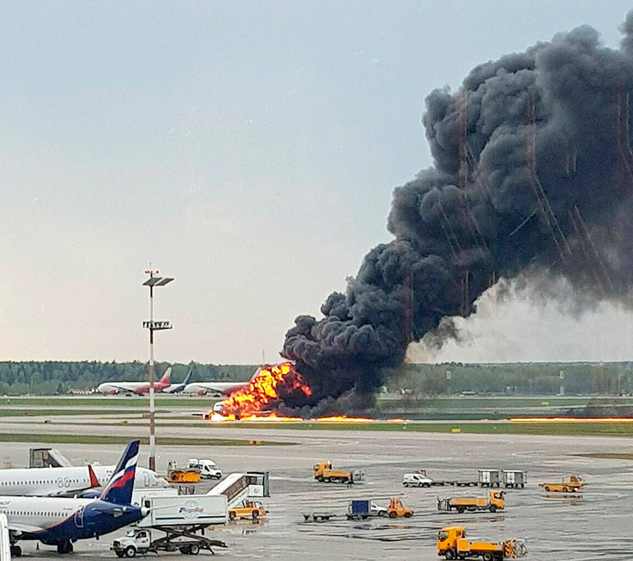 Smoke rises from a fire on a plane at Moscow’s Sheremetyevo airport on Sunday. (Riccardo Dalla Francesca via AP)