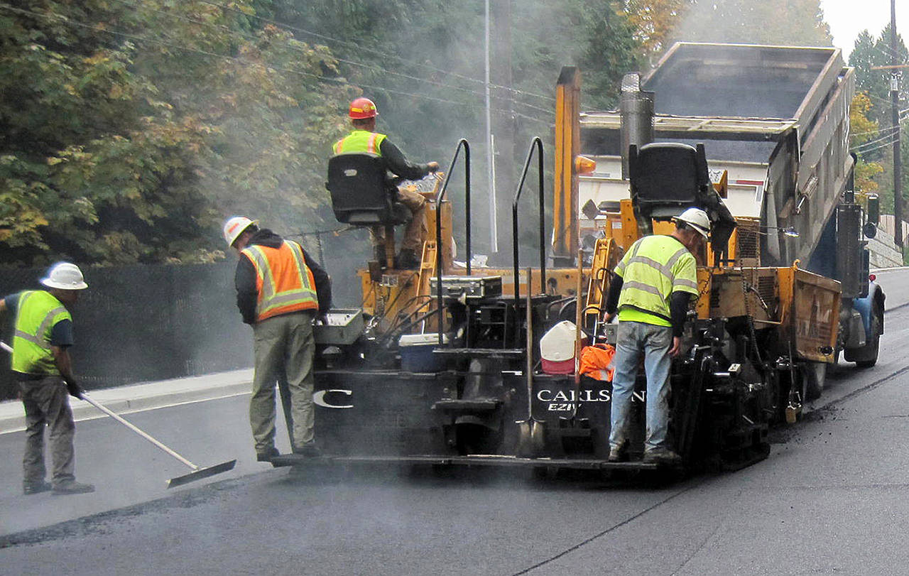 Snohomish County Public Works has begun its summer 2019 paving and chip sealing work. This photo shows paving crews from a previous summer. (Snohomish County Public Works)