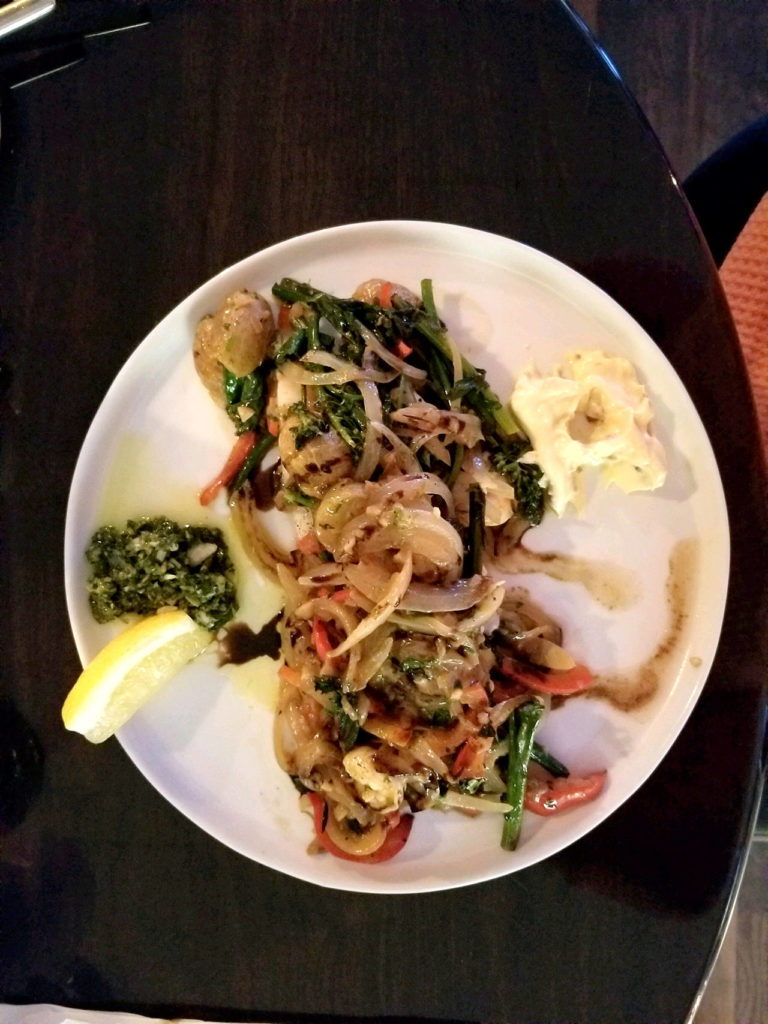 The Basque-style cod fillet is baked over a saute of broccolini, red peppers, onions, baby red potatoes, shrimp with chicken stock, brandy, wine and butter. It comes with chimichurri sauce and bacon aioli on the side for dipping. (Pam Bruestle)
