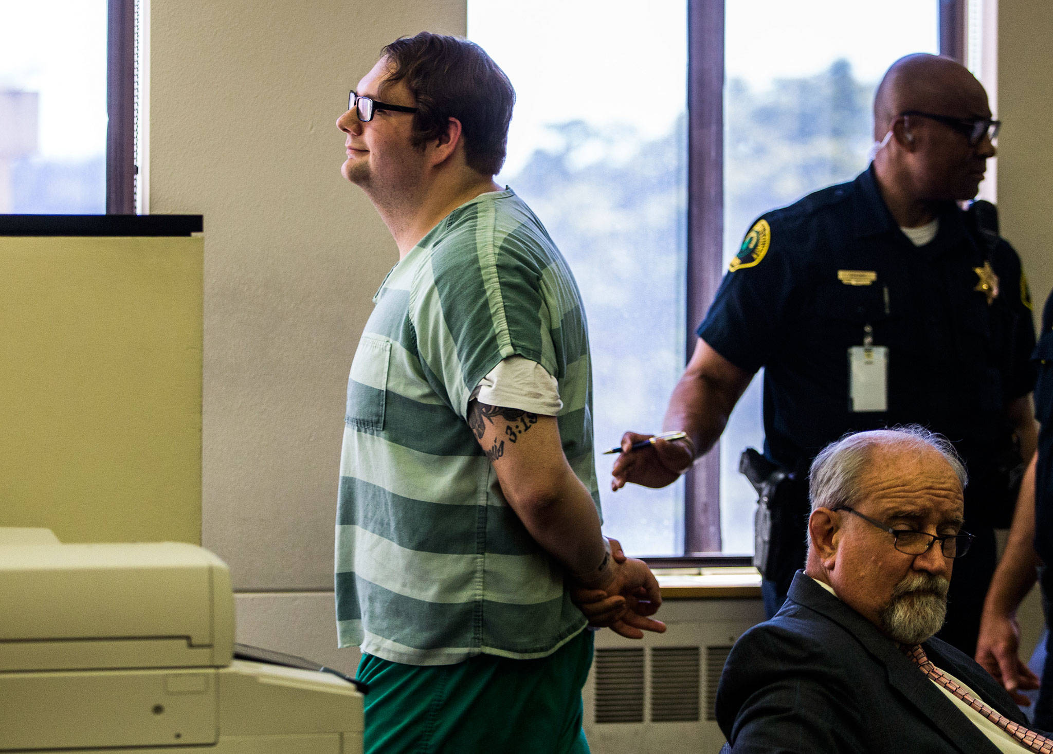Dakota Reed smiles as he walks out of the courtroom after pleading guilty to two counts of threats to bomb or injure property at the Snohomish County Courthouse on Friday. (Olivia Vanni / The Herald)
