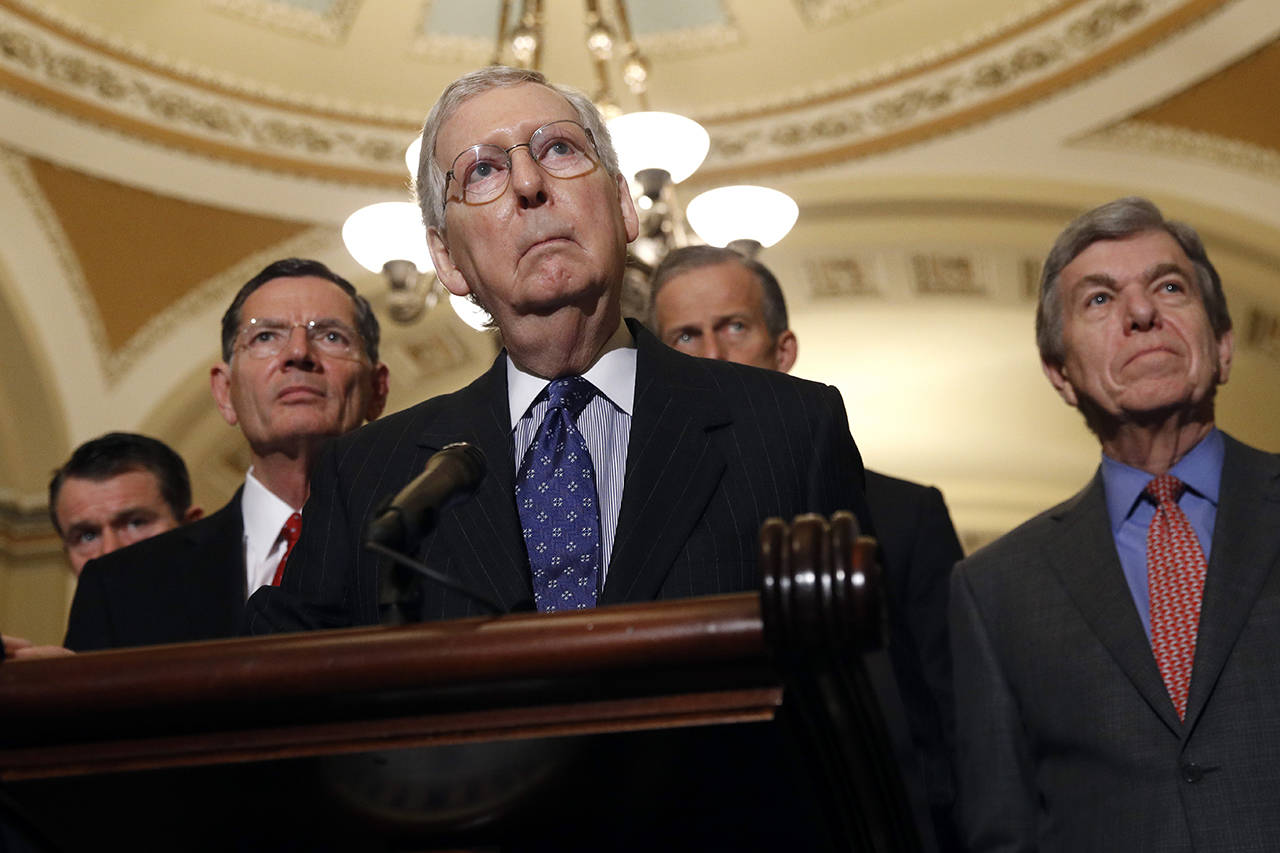 Senate Majority Leader Mitch McConnell (center), joined by (from left) Sen. Todd Young, R-Ind., Sen. John Barrasso, R-Wyo., Majority Whip John Thune, R-S.D., and Sen. Roy Blunt, R-Mo., listens to a reporter’s question following a Senate policy luncheon, Tuesday on Capitol Hill in Washington. (AP Photo/Patrick Semansky)
