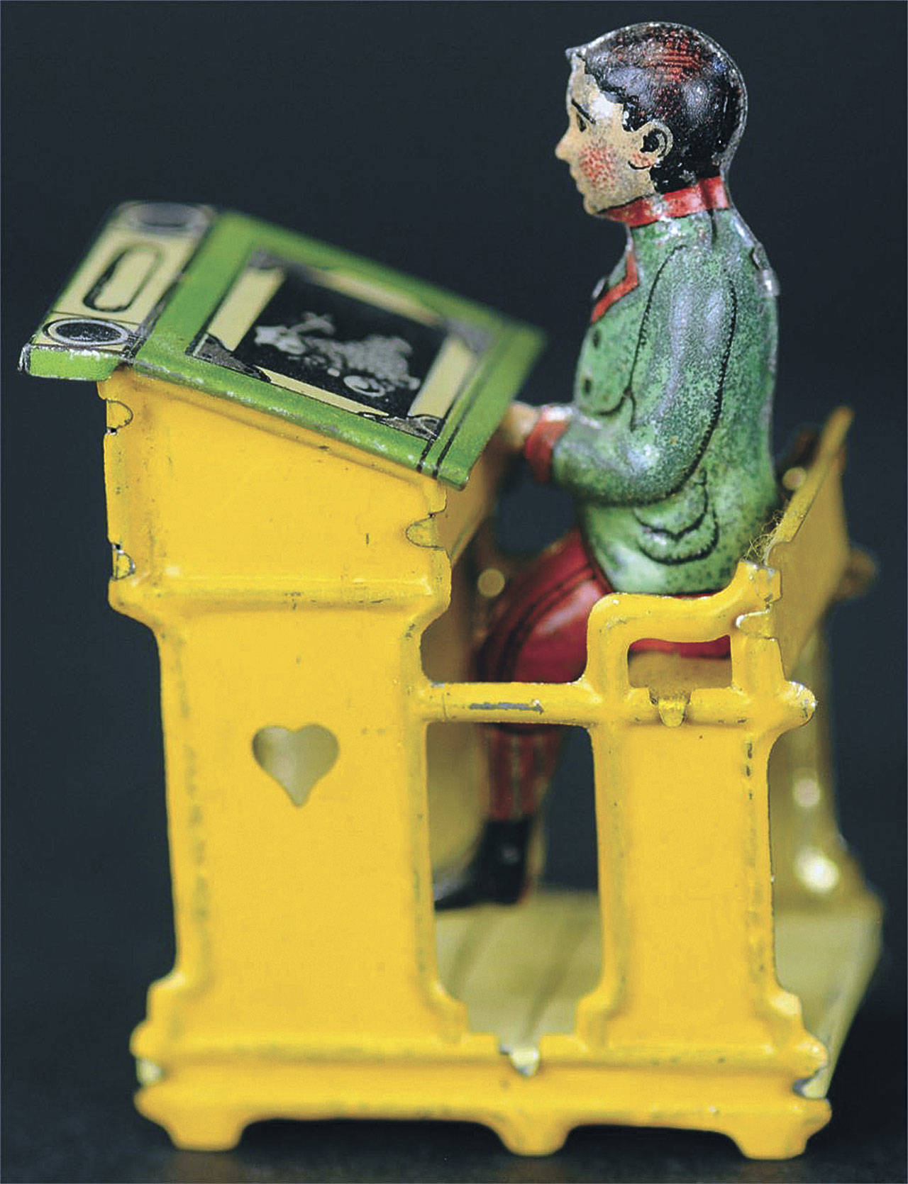 Cowles Syndicate Inc.                                The toy schoolboy sold at auction was admiring a picture on the desk top that was hiding candy. Discovering and eating the candy made the toy great fun. Today it is a collector’s treasure costing $840. The excellent condition of the original paint adds to the price.                                The toy schoolboy sold at auction was admiring a picture on the desk top that was hiding candy. Discovering and eating the candy made the toy great fun. Today it is a collector’s treasure costing $840. The excellent condition of the original paint adds to the price.                                 Cowles 
Syndicate Inc.
