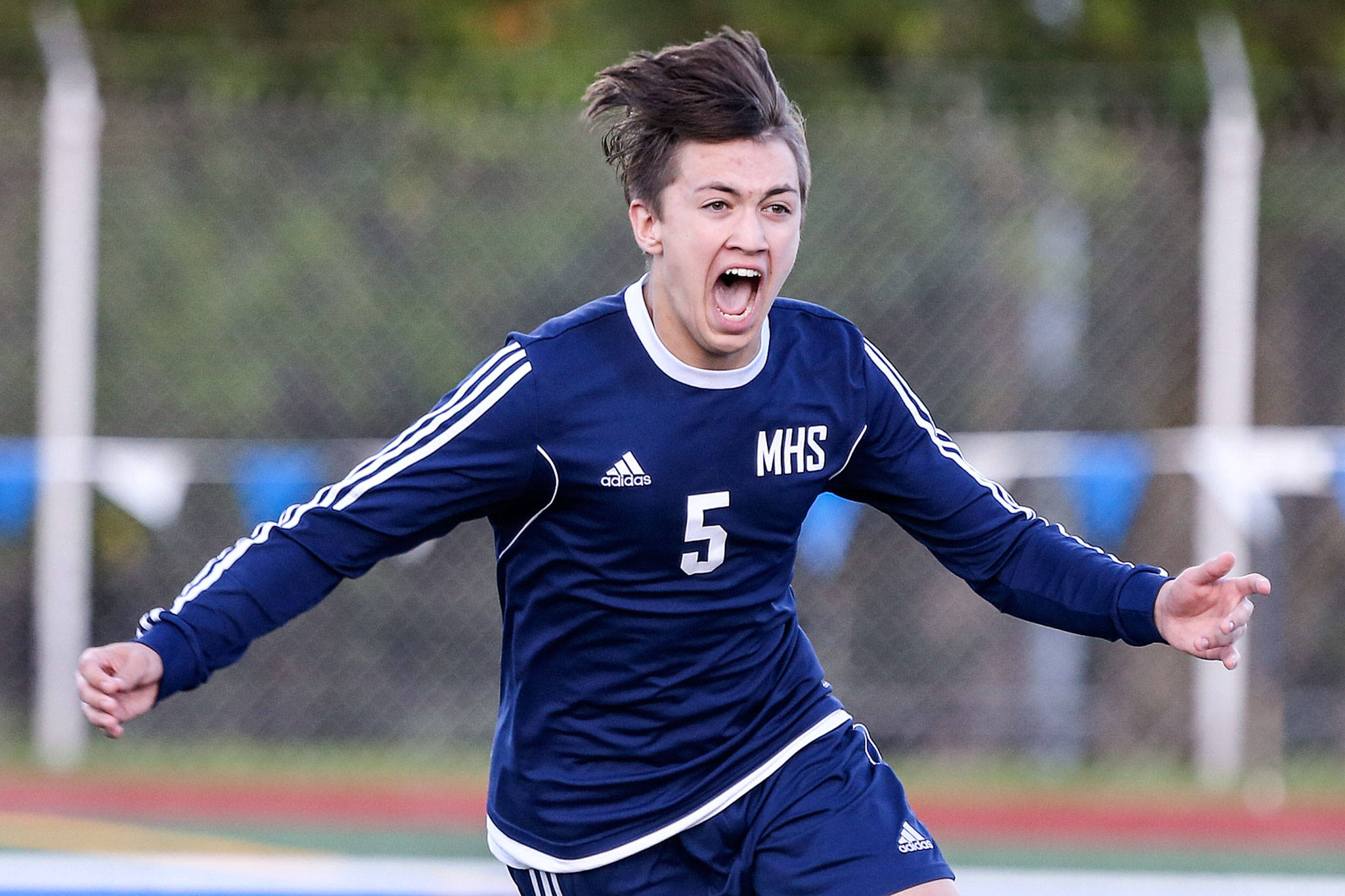 Meadowdale’s Ethan Borland celebrates his match-winning penalty kick after a 3A district semifinal against Edmonds-Woodway on May 7, 2019, at Shoreline Stadium. (Kevin Clark / The Herald)