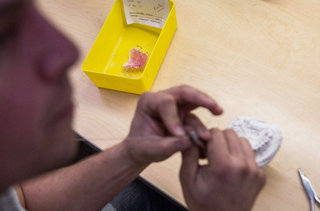 Jim Beierle demonstrates retainer wire work at Valley Orthodontic Laboratory in Snohomish. (Olivia Vanni / The Herald) 
