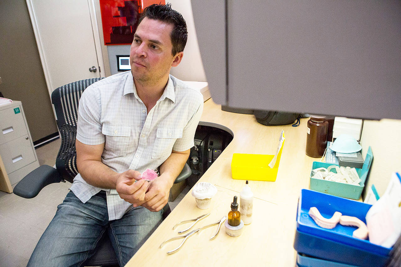 Jim Beierle talks about how they repair and fill retainers at Valley Orthodontic Laboratory in Snohomish. (Olivia Vanni / The Herald)