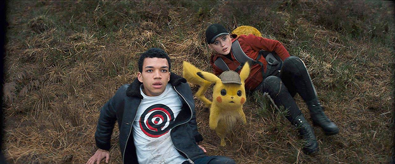 Kathryn Newton and Justice Smith play two of the human characters in “Pokemon: Detective Pikachu.” Ryan Reynolds voices the title character. (Warner Bros. Pictures)