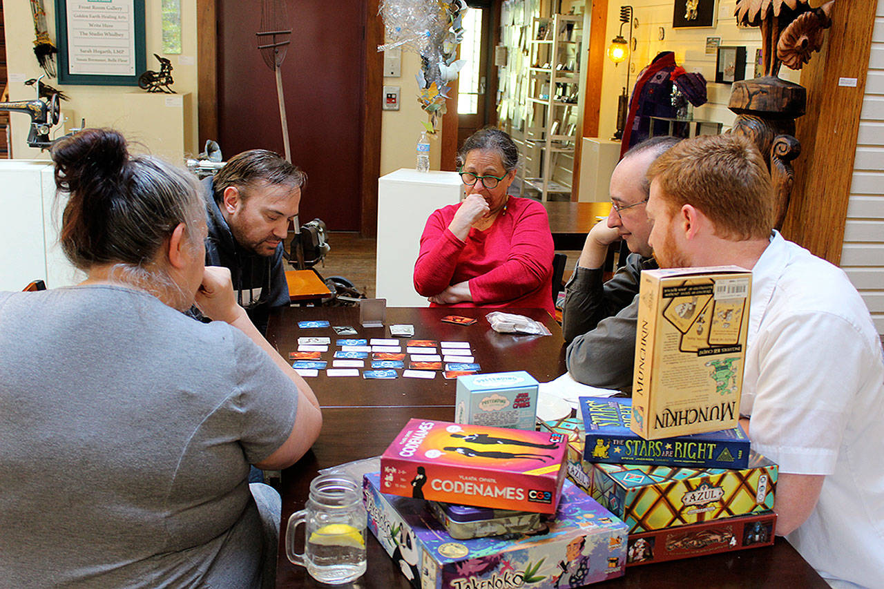 At Sunday’s gathering of game enthusiasts, Codenames was one of several mind teasers. Left to right are TammyCox, Paul Millunzi, Janet Bizar, Brian Murphy and George Nichols. (Photos by Patricia Guthrie/Whidbey News-Group)