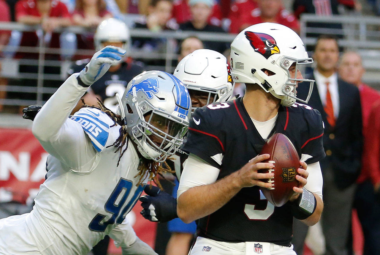 Lions defensive end Ezekiel Ansah (left) looks to sack Cardinals quarterback Josh Rosen during a game on Dec. 9, 2018, in Glendale, Ariz. (AP Photo/Rick Scuteri)