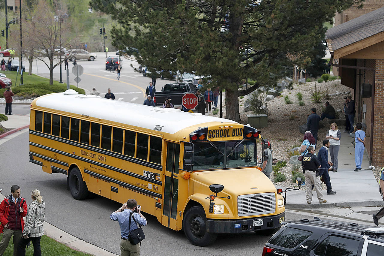 A school bus carries children to a recreation center set up for parent-student reunions after a shooting at a suburban Denver middle school Tuesday in Highlands Ranch, Colorado. (David Zalubowski / Associated Press)