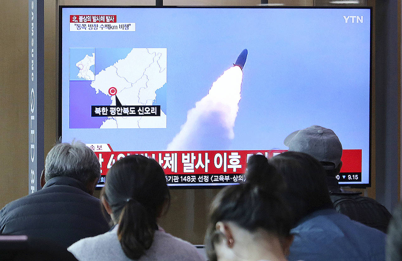 People watch a TV showing file footage of North Korea’s missile launch during a news program at the Seoul Railway Station in Seoul, South Korea, on Thursday. (AP Photo/Ahn Young-joon)