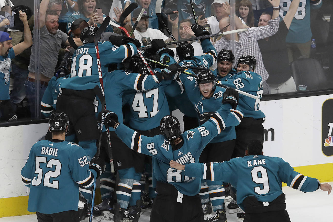 San Jose Sharks players celebrate after defeating the Vegas Golden Knights in Game 7 of an NHL hockey first-round playoff series in San Jose, Calif., Tuesday, April 23, 2019. The Sharks won 5-4 in overtime. (AP Photo/Jeff Chiu)