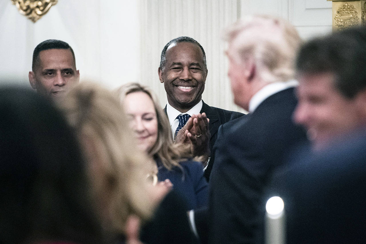 Secretary of Housing and Urban Development Ben Carson watches as President Trump and first lady Melania Trump arrive for a dinner celebrating evangelical leadership in the State Dining Room of the White House on Aug. 27, 2018. (Jabin Botsford/Washington Post, file)