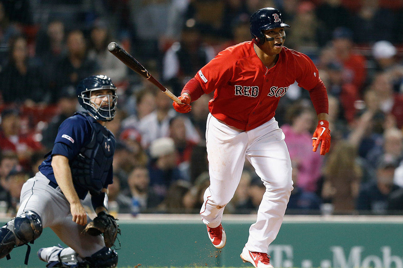 The Red Sox’s Rafael Devers watches his two-run double in front of Mariners catcher Tom Murphy during the eighth inning of a game on May 10, 2019, in Boston. (AP Photo/Michael Dwyer)