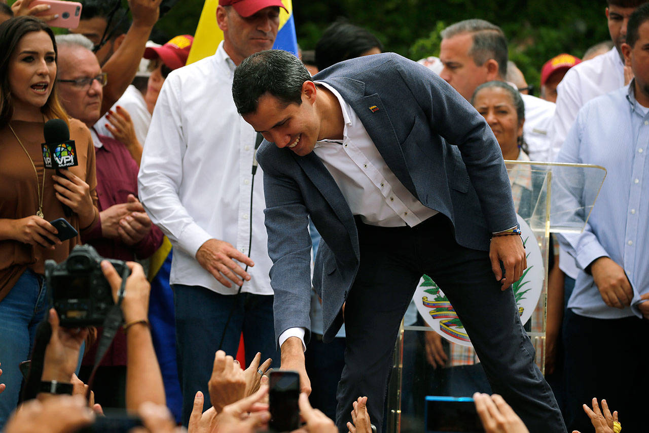 Opposition leader Juan Guaidó greets supporters as he arrives to lead a rally Saturday in Caracas, Venezuela. Guaidó has called for nationwide marches protesting the Maduro government, demanding new elections and the release of jailed opposition lawmakers. (AP Photo/Fernando Llano)