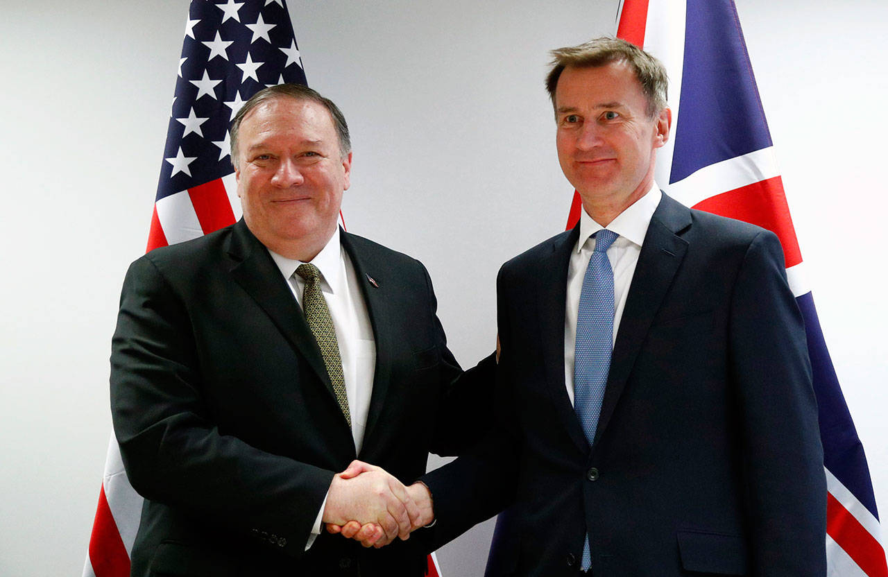 U.S. Secretary of State Mike Pompeo (left) poses with Britain’s Foreign Secretary Jeremy Hunt on Monday at the European Council in Brussels. Pompeo has changed the schedule for his latest trip to Europe, substituting a stop in Brussels for one in Moscow to discuss Iran and other issues with European officials. State Department spokesman Morgan Ortagus says Pompeo is still expected to meet Tuesday in Sochi with Russian President Vladimir Putin and Foreign Minister Sergey Lavrov. (Francois Lenoir/Pool Photo via AP)