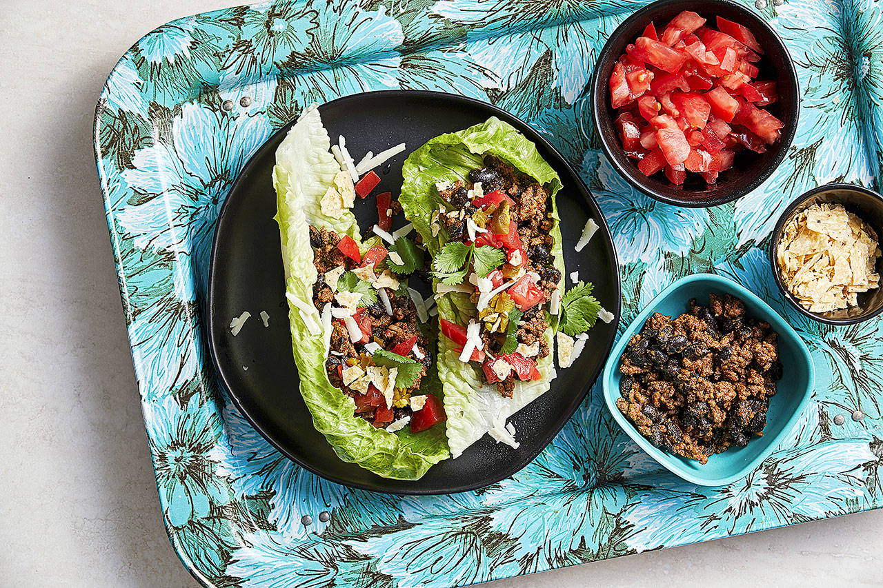 Turn tacos inside out by using lettuce leaves in place of the shells and crunchy tortilla chips as one of the toppings. (Photo for The Washington Post by Tom McCorkle; food styling for The Washington Post by Lisa Cherkasky)