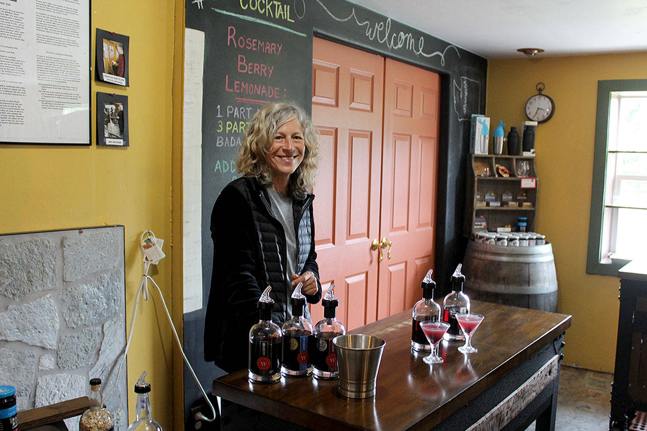 Whidbey Island Distillery spirits guide Michelle Molner pours two speciality craft cocktails for customers. The company is releasing Lavender Infused Loganberry Liqueur as part of its Savor Spring offerings. (Patricia Guthrie / Whidbey News Group)
