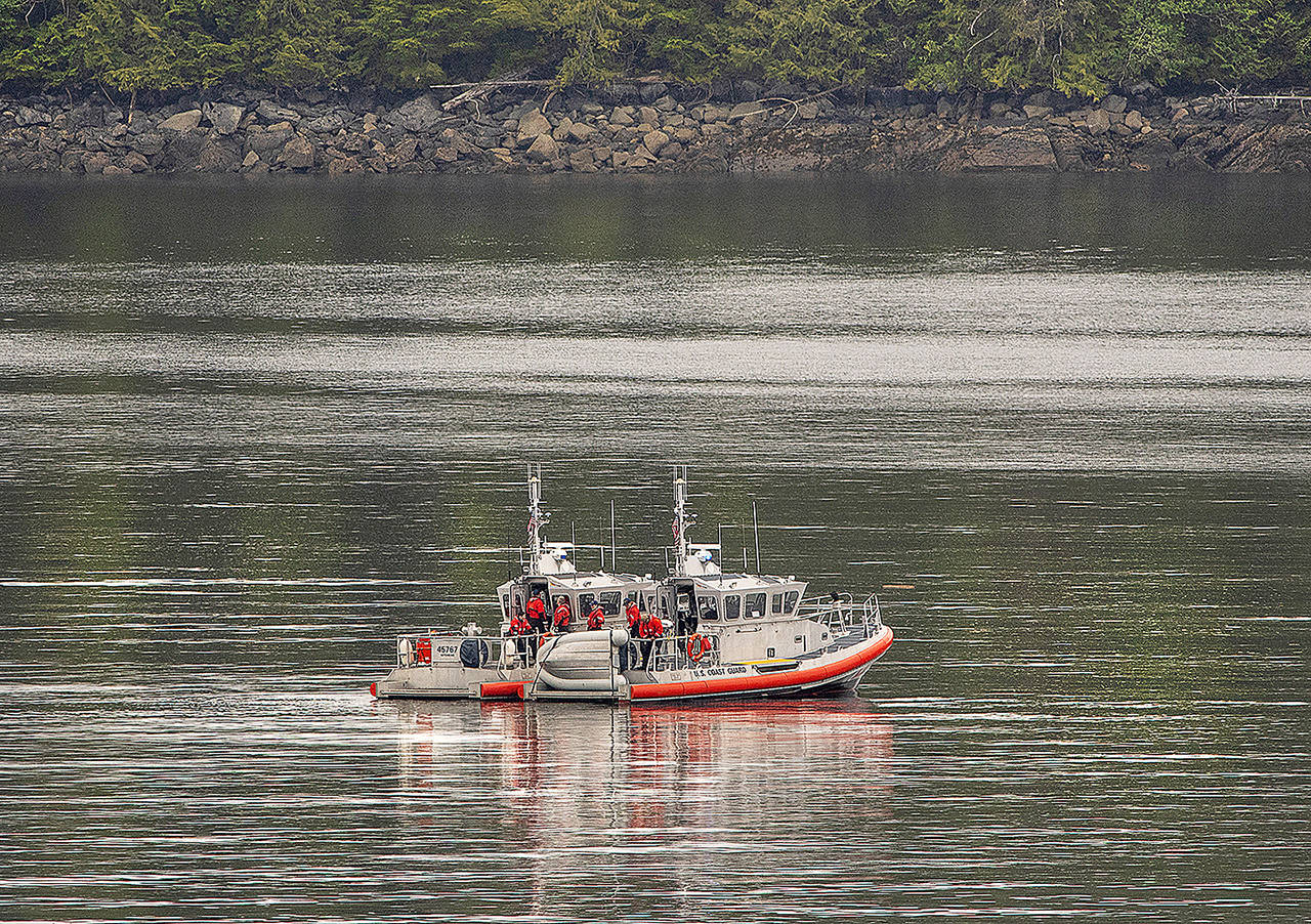 Two U.S. Coast Guard 45-foot response boats drift through George Inlet as part of a search effort on Tuesday near Ketchikan, Alaska, at the site of a collision between two float planes. (Dustin Safranek/Ketchikan Daily News via AP)
