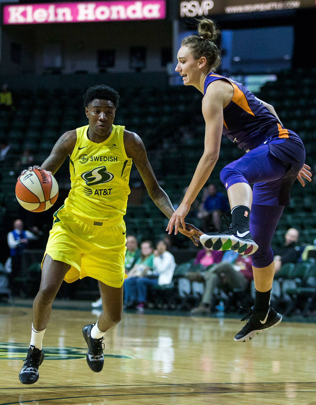 Seattle’s Natasha Howard dribbles around Phoenix’s Stephanie Talbot during a preseason game against Phoenix on Wednesday at Angel of the Winds Arena in Everett. (Olivia Vanni / The Herald)
