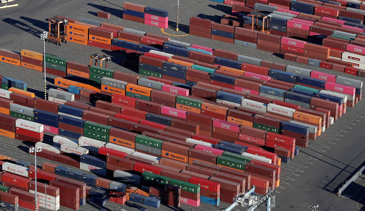 Cargo containers are staged near cranes at the Port of Tacoma, in March, in Tacoma. The 25 percent tariffs President Trump has imposed on thousands of Chinese-made products have business owners trying to determine how or whether they can limit the damage to profits from the import duties. (Ted S. Warren / Associated Press)