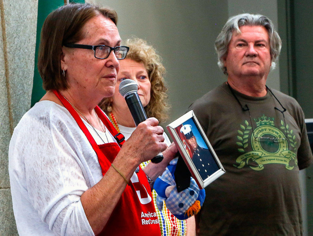 Myra Rintamaki holds a photograph of her lost son, Steven, and talks to a packed room Tuesday. Behind her, Linda Swanberg spoke of her son Shane, and Brian Starr (right) lost his son, Jeffrey. All the young men were Marines killed in Iraq. (Dan Bates / The Herald)

