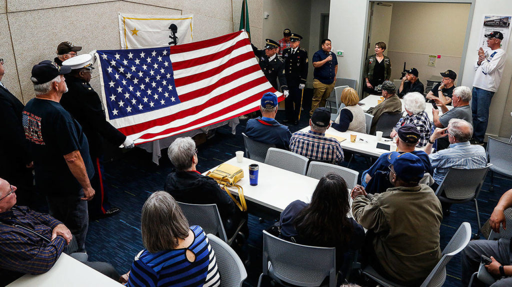 When the flag is ready to be folded and presented, bearers pause and allow Yee Hang Vang to talk about his uncle, Say Chao Thao, who served in the CIA’s secret army in Laos. (Dan Bates / The Herald)
