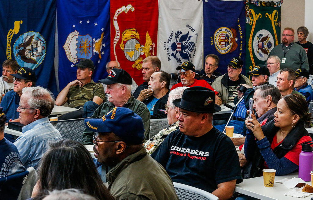 At the Hero’s Cafe in Lynnwood Tuesday, the packed house of more than 100 listens intently as Vietnam veteran Michael Reagan begins to talk. (Dan Bates / The Herald)
