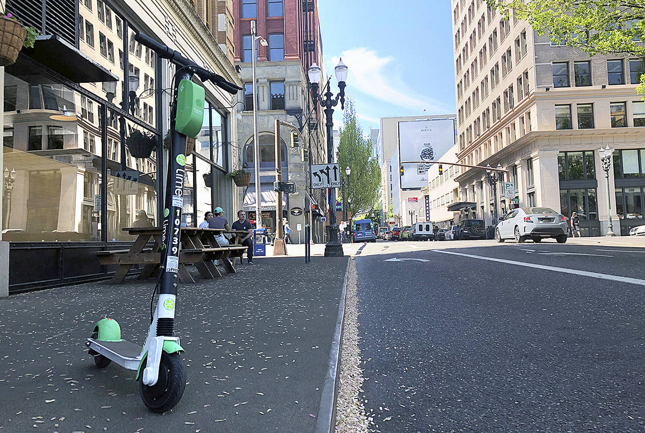 Gillian Flaccus / Associated Press file                                A Lime electric scooter on a street in downtown Portland.