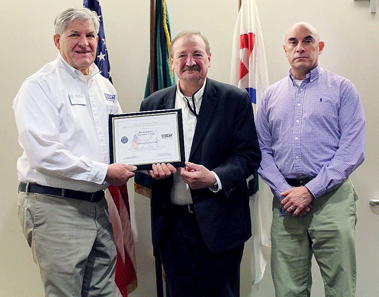 Snohomish County Executive David Somers was presented the ESGR Patriot Award at a recent county council meeting. The recognition was made by John Van Dalen (left), who is with the Washington Employer Support of the Guard Reserve. Somers was nominated by USAR CW2 David J. Lente (right), who works for the county and who serves with the 373rd E-MI BN Joint Base Lewis McCord.